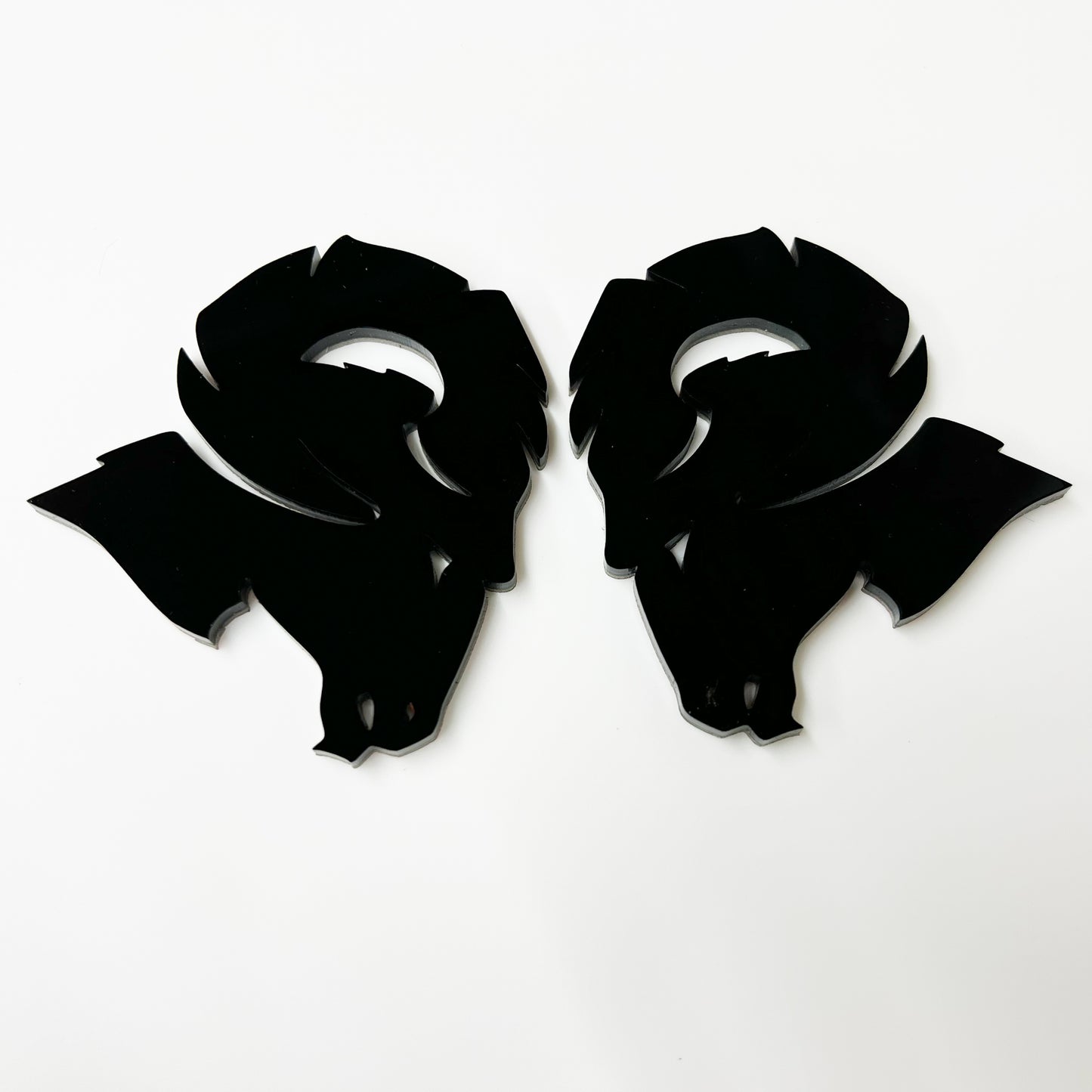 Pair of glossy black Custom Dodge Ram Hellcat Emblem badges by FMSgear on white background