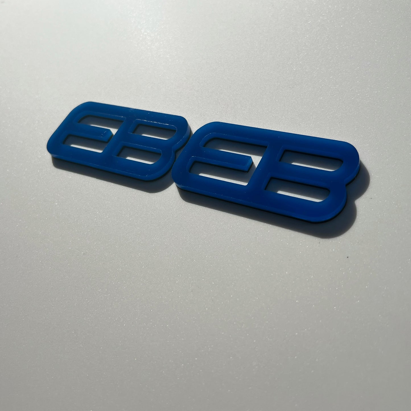 FMSgear blue custom emblems Ford Mustang f-150 badge on silver vehicle surface