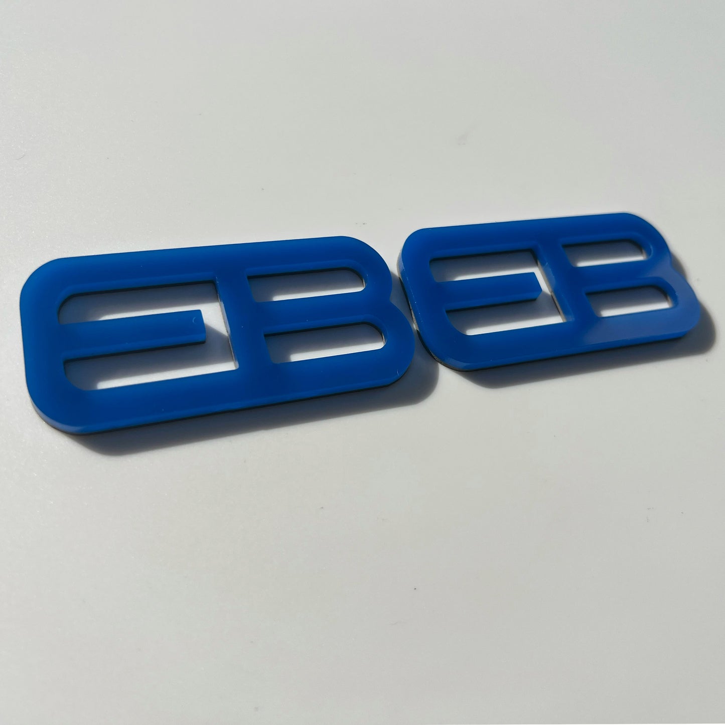 Blue custom emblems for Ford Mustang f-150 by FMSgear displayed on white background