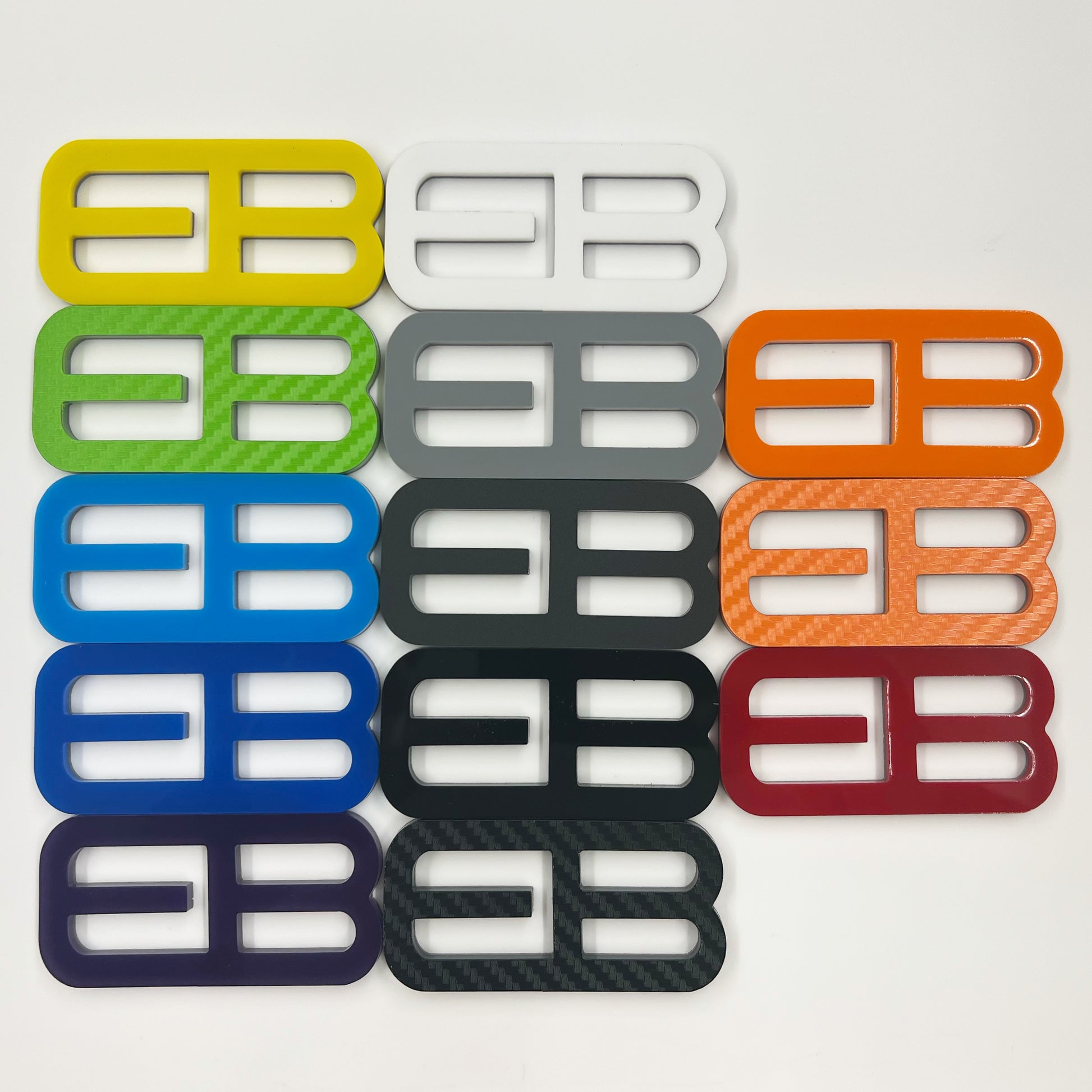 FMSgear custom emblems Ford Mustang f-150 in various colors and finishes displayed on white background