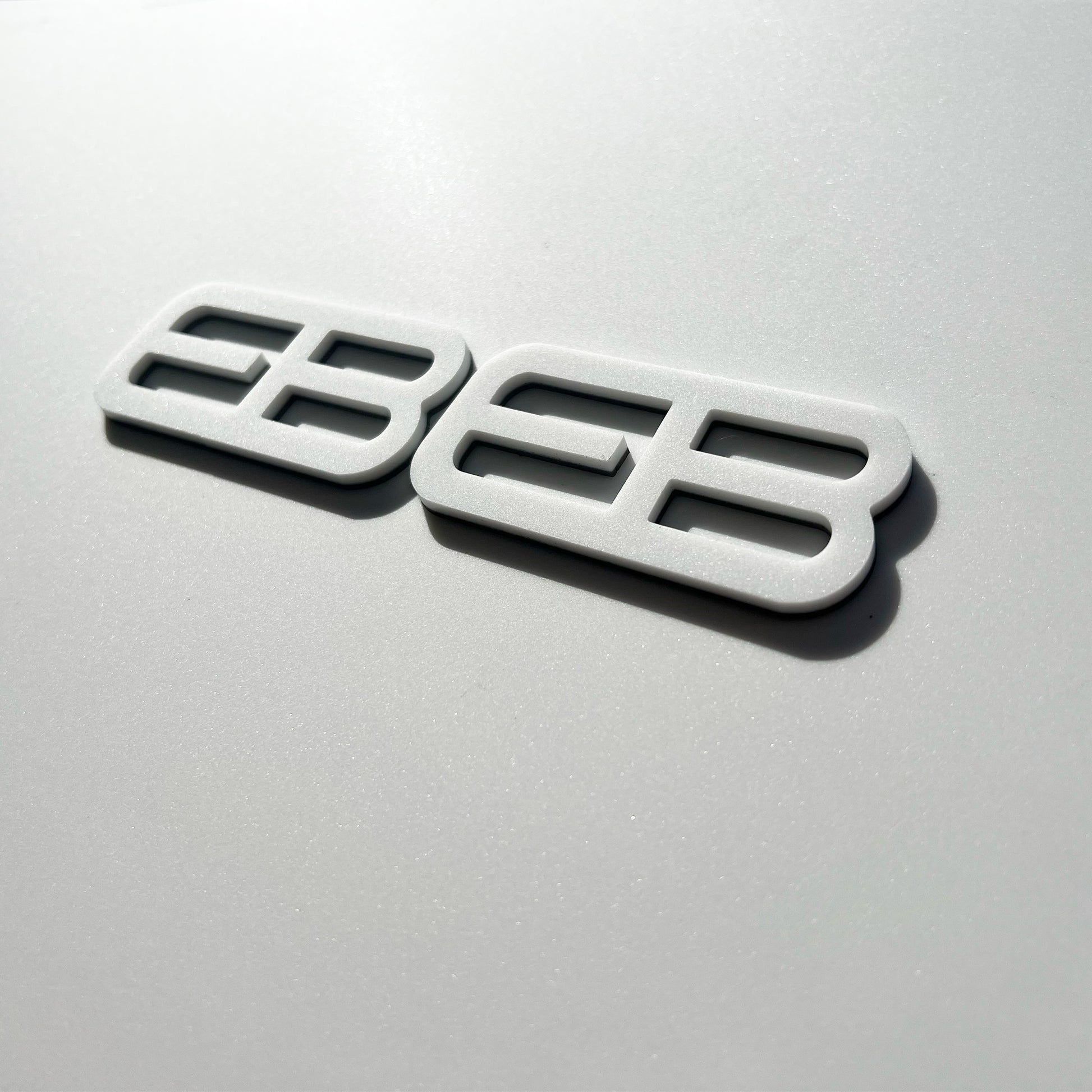 FMSgear custom emblems Ford Mustang f-150 badge in white with modern design on silver background