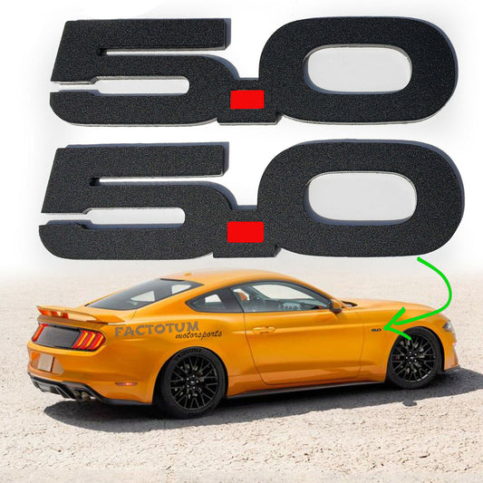 Custom Ford Mustang GT 5.0 emblems in black with red dot displayed above orange Ford Mustang GT car