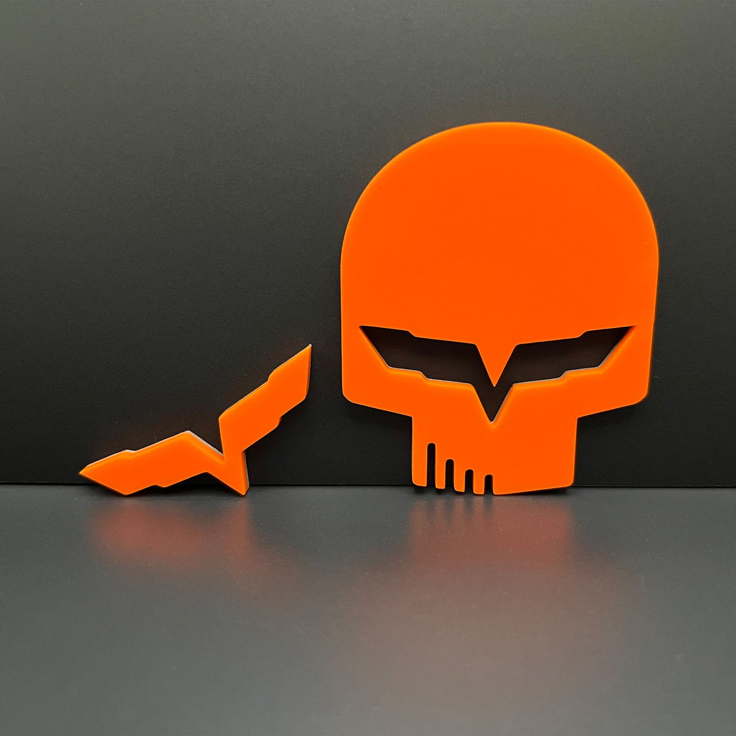 FMSgear bright orange Jake skull badge for Corvette emblem with sharp angular eye design on black background