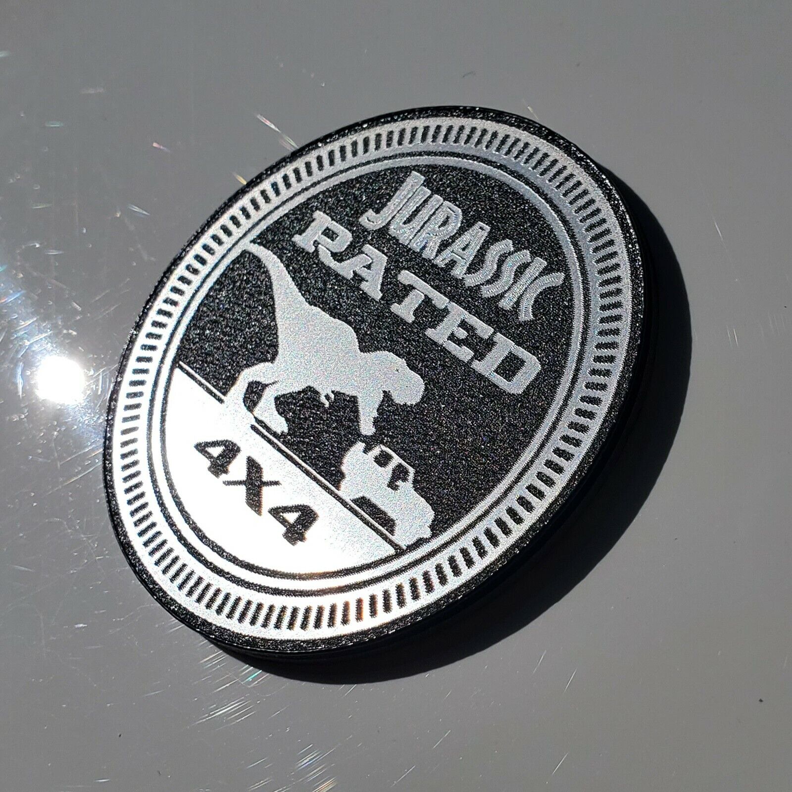 FMSgear Jurassic fender badge for jeep featuring a dinosaur and 4x4 design in silver and black