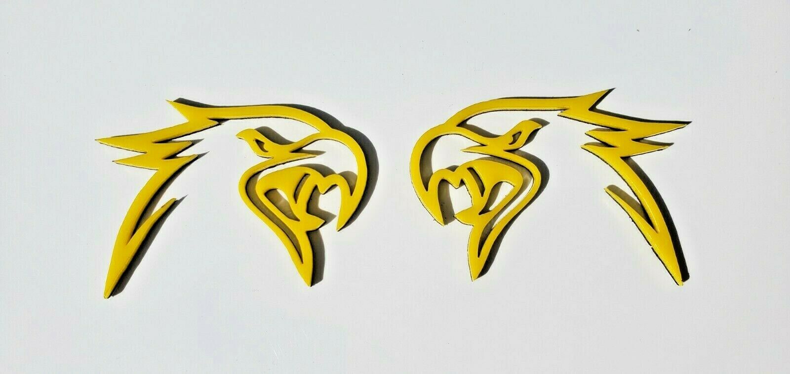 Pair of yellow and black Custom HELLHAWK emblems for Jeep by FMSgear featuring aggressive hawk head design