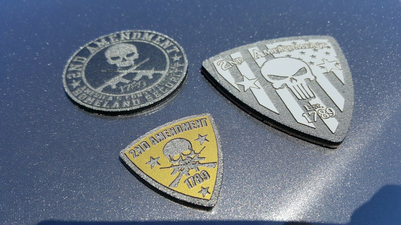 FMSgear Second Amendment car emblems featuring skull and rifle designs in silver and gold colors